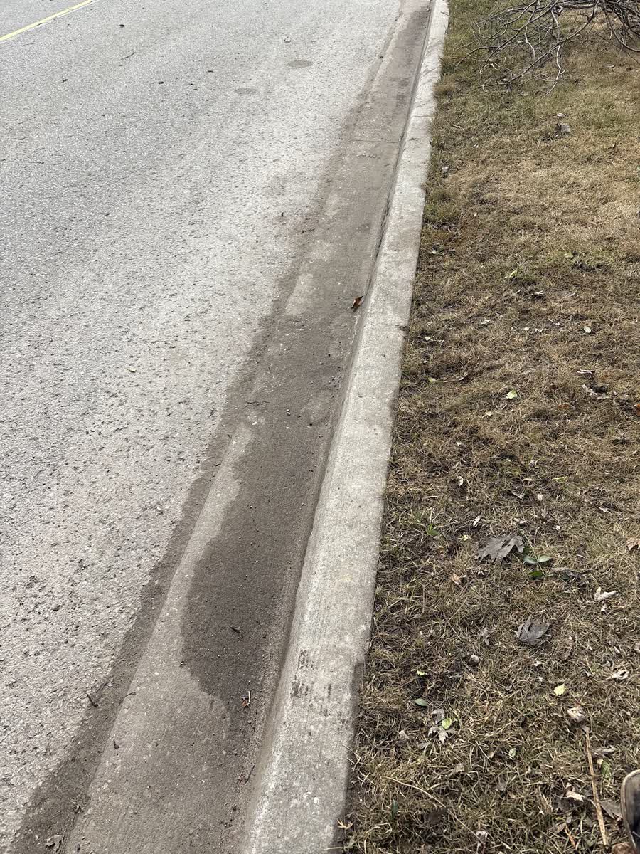 A road edge and curb at the end of the season, before the snow